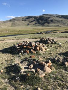 Kurgan burial mounds in an open landscape in Mongolian Altai
